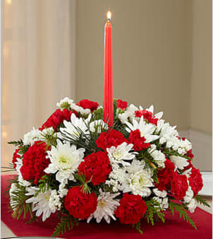 Merry Times Holiday Centerpiece - Picked fresh from the farm to bring an elegant glow to your holiday table, the Merry Times Holiday Centerpiece has a festive grace and beauty you are sure to love. Hand gathered at select floral farms and bringing together rich holiday reds, crisp whites and lush greens to form an eye-catching arrangement, this stunning centerpiece has been picked fresh for you to help you bring blooming beauty to your Christmas gathering or send your warmest season's greetings to friends and family near and far. Centerpiece includes: white chrysanthemums, red carnations, red mini carnations, white statice, lush holiday greens and a single red taper candle at the center. Approx. 7&quot;H x 12&quot;W.  Your purchase includes a complimentary personalized gift message.