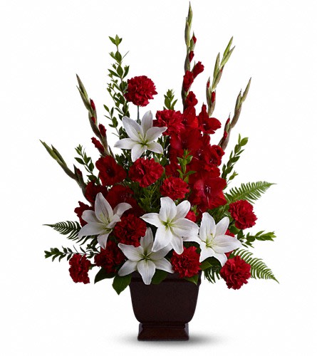 Teleflora's Tender Tribute - Vivid and touching vibrant reds and serene whites blend in honor and celebration of a life filled with love light and grace. Beautiful fresh flowers such as red gladioli and carnations with white asiatic lilies set amidst myrtle sword fern and salal in an exclusive Noble Heritage Urn.Approximately 24&quot; W x 34&quot; H Orientation: One-Sided As Shown : T227-1A