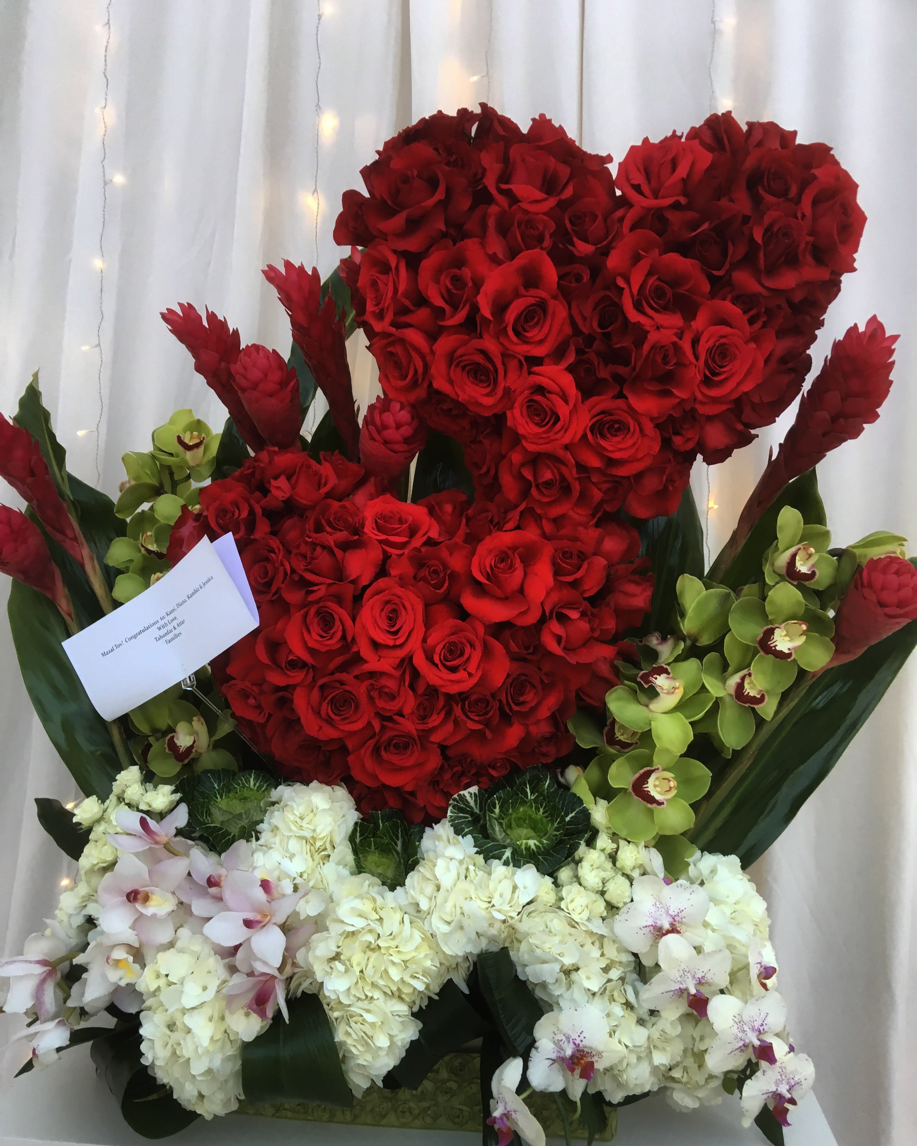 Its A Love Story' - Red roses, ginger, green orchids