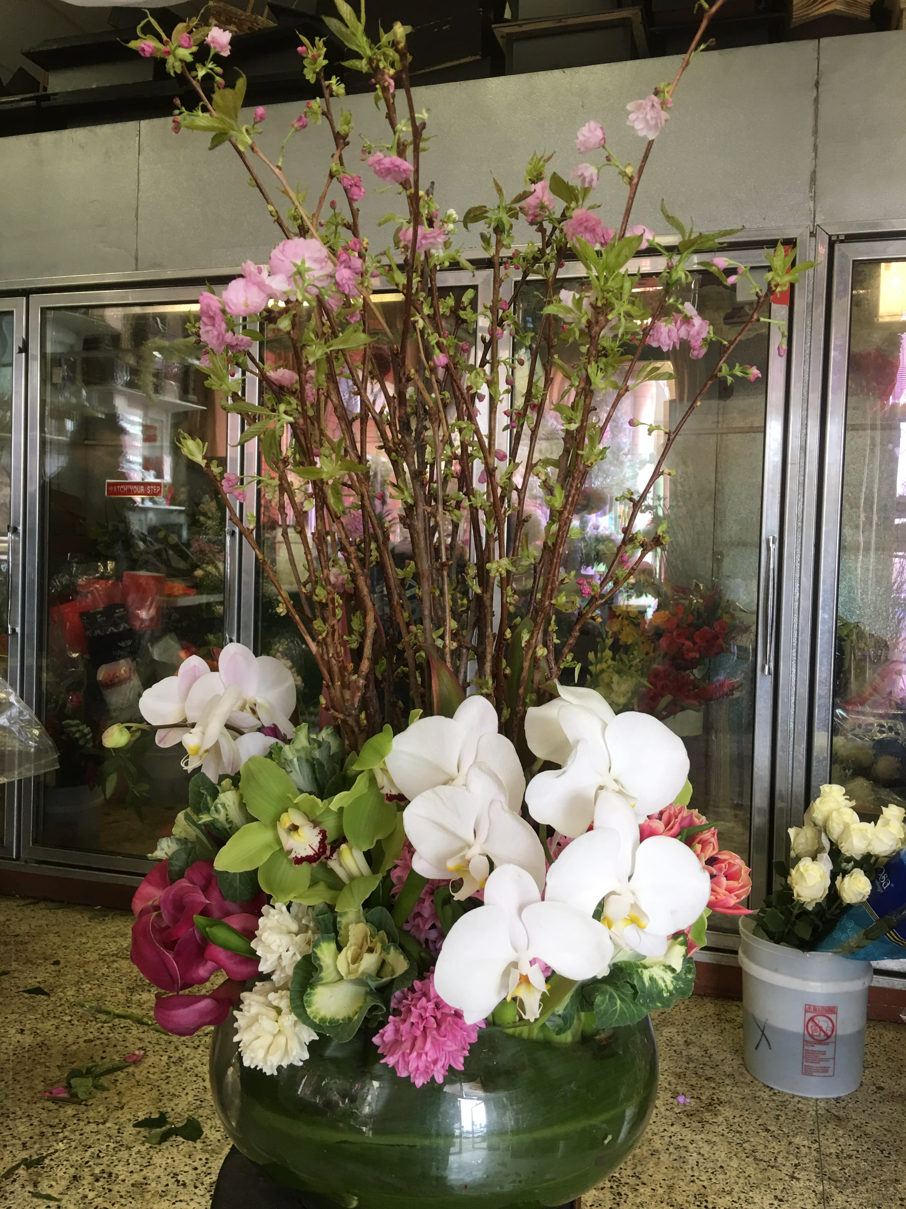 Cherry Blossom Zen - Orchids &amp; mini calla lilies intertwined with Cherry blossom branches giving this grand round bowl vase a Japanese zen garden look