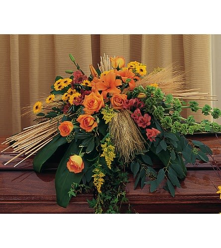 Autumn Faith Casket Spray Autumn Faith Casket Spray - This casket spray with its vibrant autumn flowers will offer up plenty of comfort to friends and loved ones alike. One casket spray arrives with vibrant orange lilies and roses chrysanthemums and alstroemeria accented with bunches of dried wheat.Approximately 39" W x 44" H Orientation: All-Around As Shown : TF210-1 Available for local delivery only
