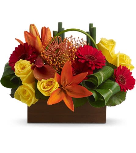 Teleflora's Bamboo Getaway Teleflora's Bamboo Getaway - Get away from bouquets as usual and choose this tropical adventure strikingly served up in a beautiful bamboo box. Exotic. Exciting. Extremely beautiful! Yellow roses dark orange miniature callas orange asiatic lilies and pin cushion protea red miniature gerberas and more are delivered in a unique rectangular bamboo container. It's definitely a departure from the ordinary!Approximately 13 1/4" W x 10" H Orientation: One-Sided As Shown : T85-3ADeluxe : T85-3BPremium : T85-3C