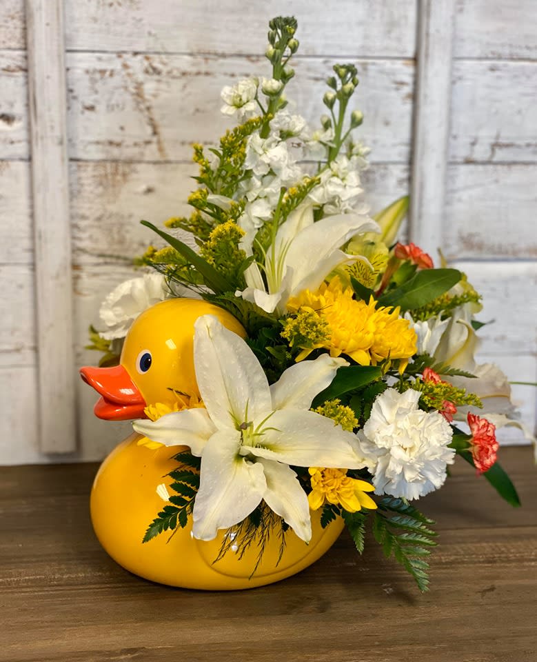 CFB108 - A keepsake Yellow Duck container filled with an arrangement of Yellow, White &amp; Orange Flowers. 