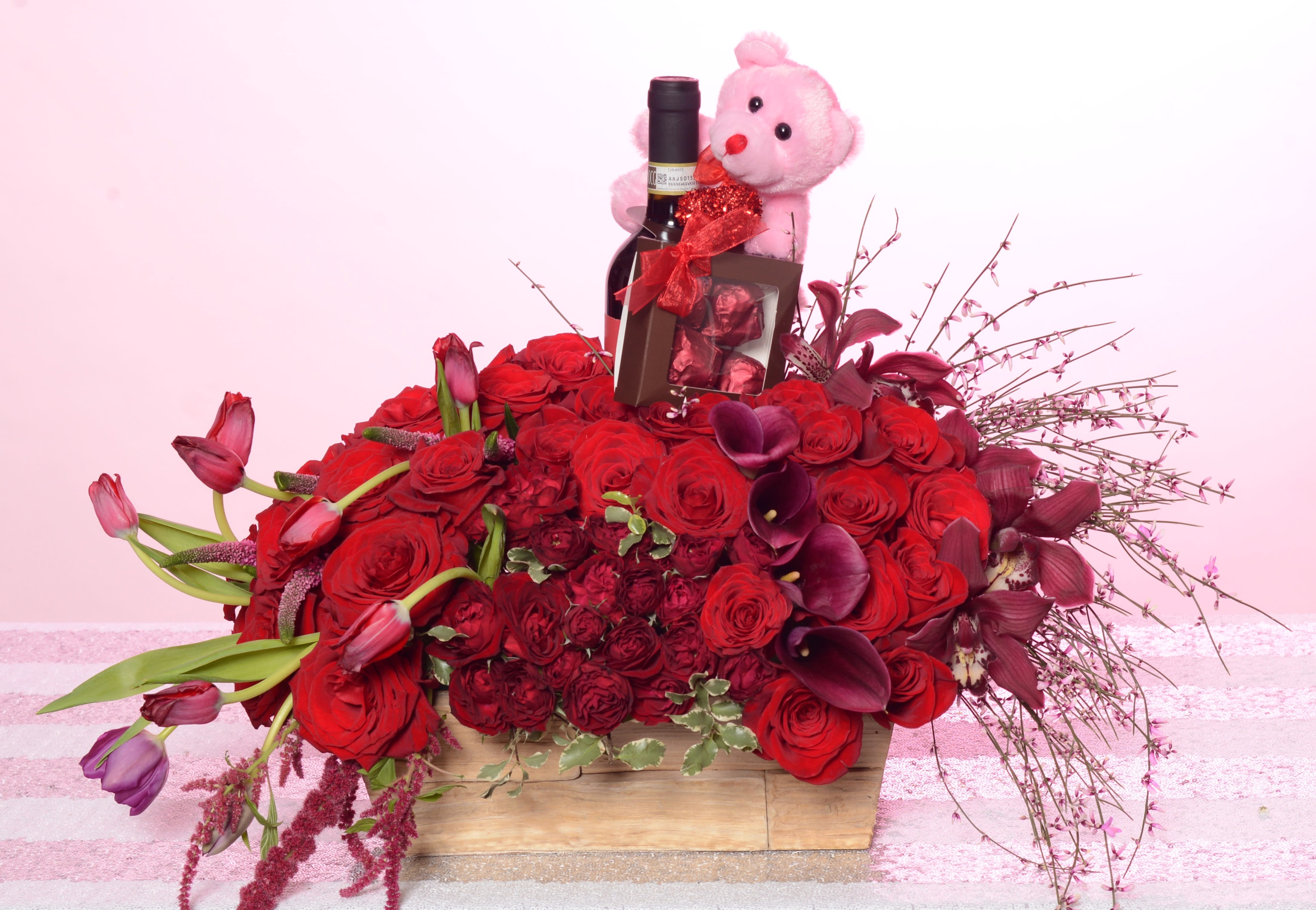 Full Of Love Full Of Love - Composed of Cala Lilies, Tulips, Amaranthus, Spray Roses, Roses. Bear and chocolate included. Wine not included.