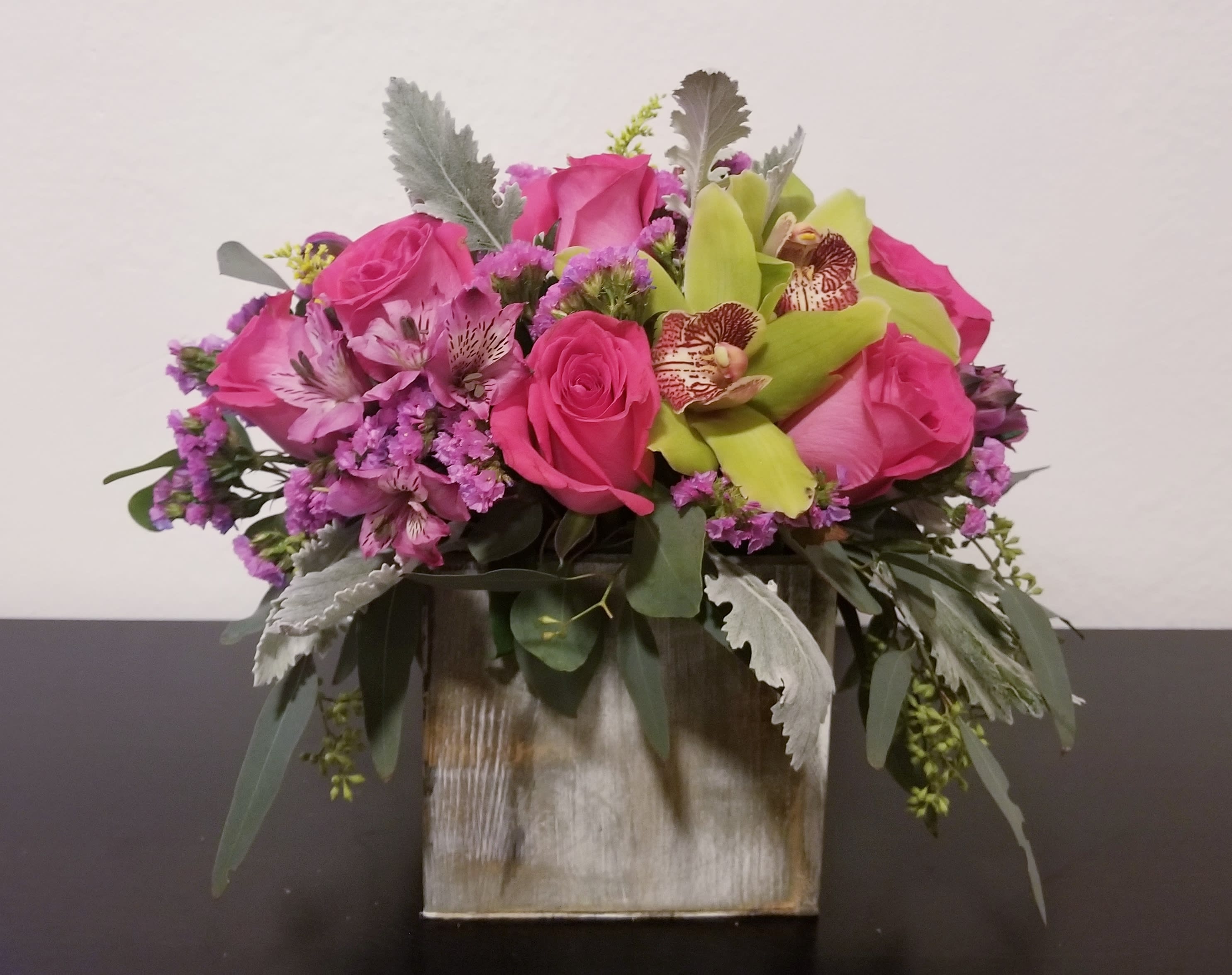 Enchanted Enchanted - Composed of Roses, orchids, alstroemeria, variety of green.