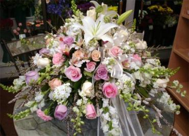 The Pastel Casket Spray - This spledid casket spray is arranged with roses, tulips, orchids, and lilies, this spray is an elegant and sophisticated display for the casket top.      Approx. 30&quot;h x 48&quot;w  