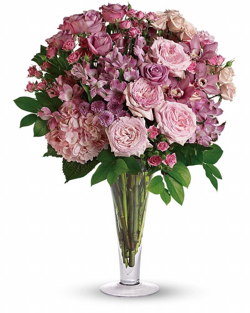 A La Mode Bouquet with Long Stemmed Roses - When it comes to declaring your love, there can be no doubt about your intentions when you go all out with this spectacular bouquet of orchids, roses and other favorites in a stylish flared glass vase. Go for it - and she's sure to go for you. This exquisite bouquet includes pink orchids, pink hydrangea, pink roses, lavender roses, pink spray roses, light pink spray roses, pink alstroemeria and lavender button spray chrysanthemums accented with assorted greenery. Delivered in a flared glass vase.