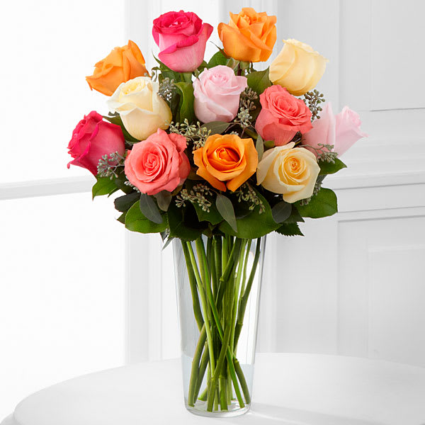 The FTD Graceful Grandeur Rose Bouquet - The FTD® Graceful Grandeur™ Rose Bouquet offers your special recipient a bright assortment of roses to bring them joy with its exquisite beauty. Cream orange hot pink coral and light pink roses are accented with lush greens and gorgeously arranged within a clear glass vase to create a lovely way to send your love say thank you or even to extend your happy birthday wishes.