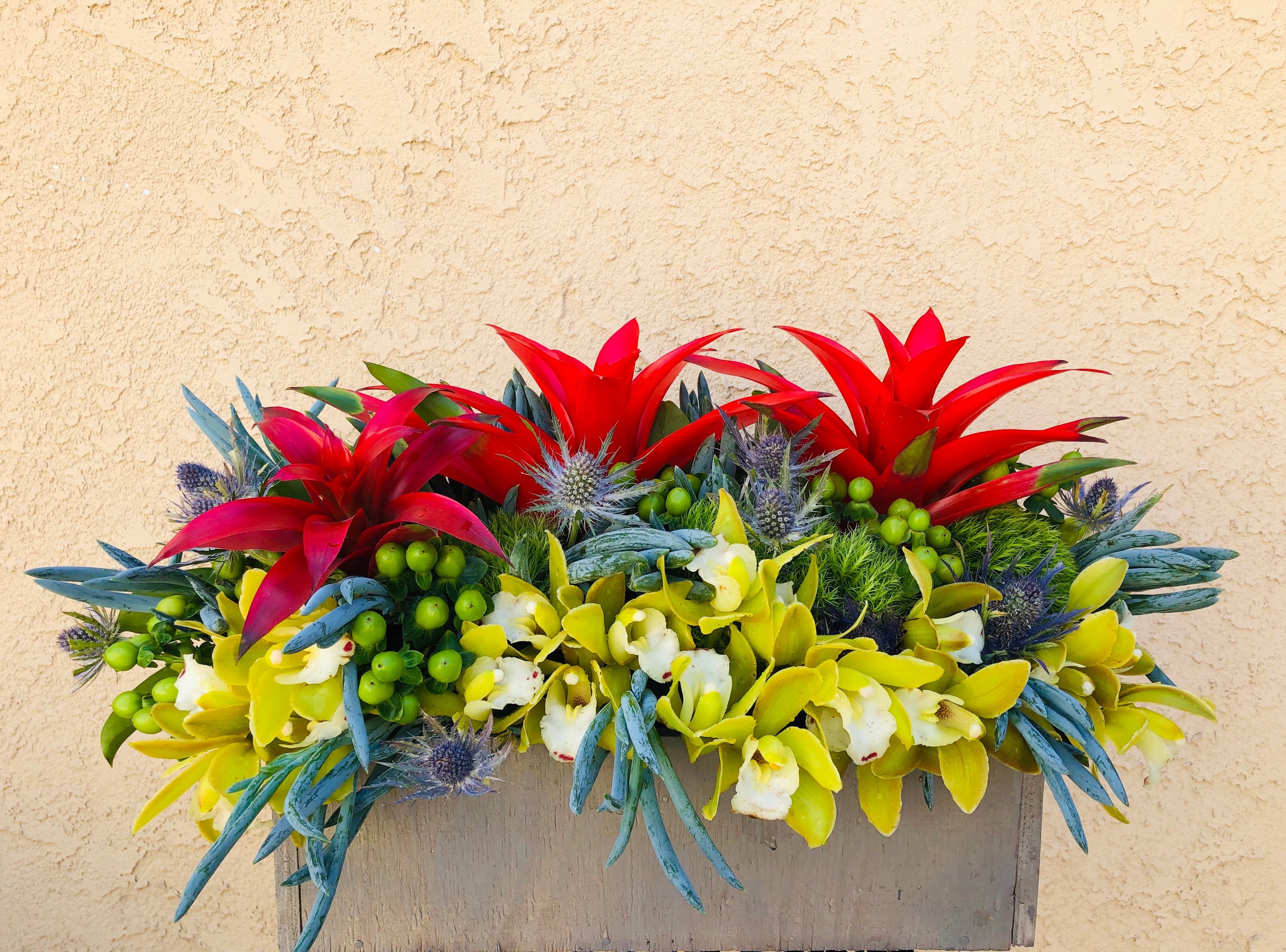 Tropical Island - Tropical design including red protea, orchid, green hypericum, sea holly and accents.