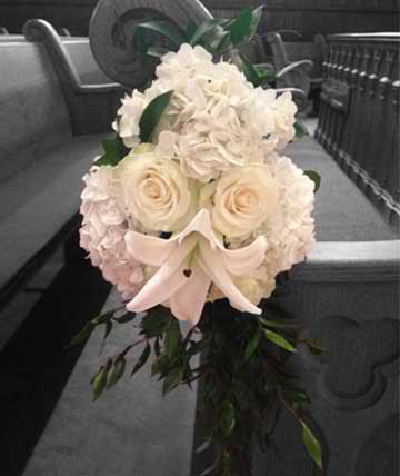 Pew Decoration Pew Decoration - All white pew flowers of roses, lily, and hydrangea. Substitutions of equal or greater value may be made depending on season and availability of product or container