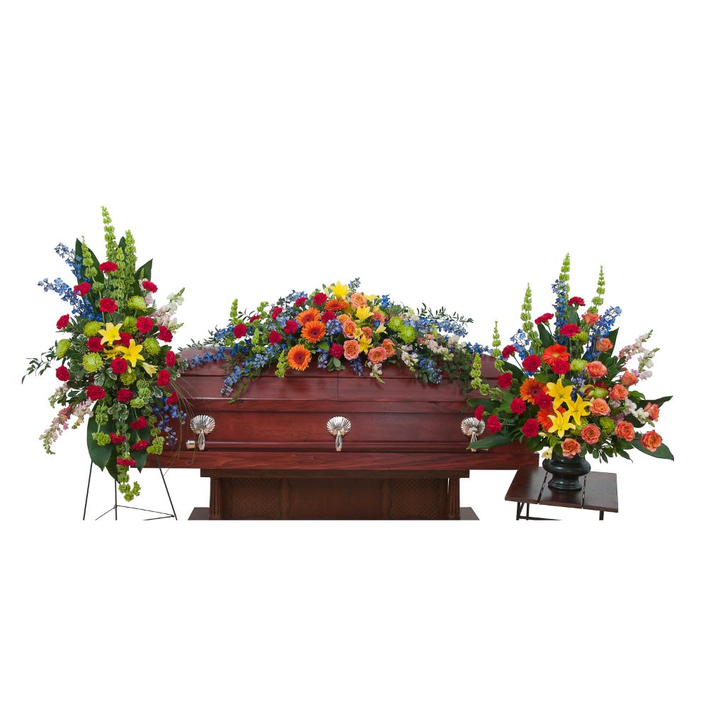 Treasured Celebration Trio - The treasured celebration trio includes a casket spray, standing easel spray and crescent urn arrangement.