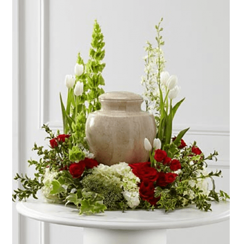 Tears of Comfort (FTD) Tears of Comfort (FTD) - The FTD® Tears of Comfort™ Arrangement is an elegant and sophisticated way to surround their urn with floral beauty at the final farewell service. Rich red roses and spray roses are vivid and bright amongst white tulips, larkspur, hydrangea and trachelium, accented with the bright greens of Bells of Ireland, hypericum berries, ivy and myrtle, creating a wonderful way to honor the life of the deceased. Approximately 21"H x 24"W SKU#: S17-4473