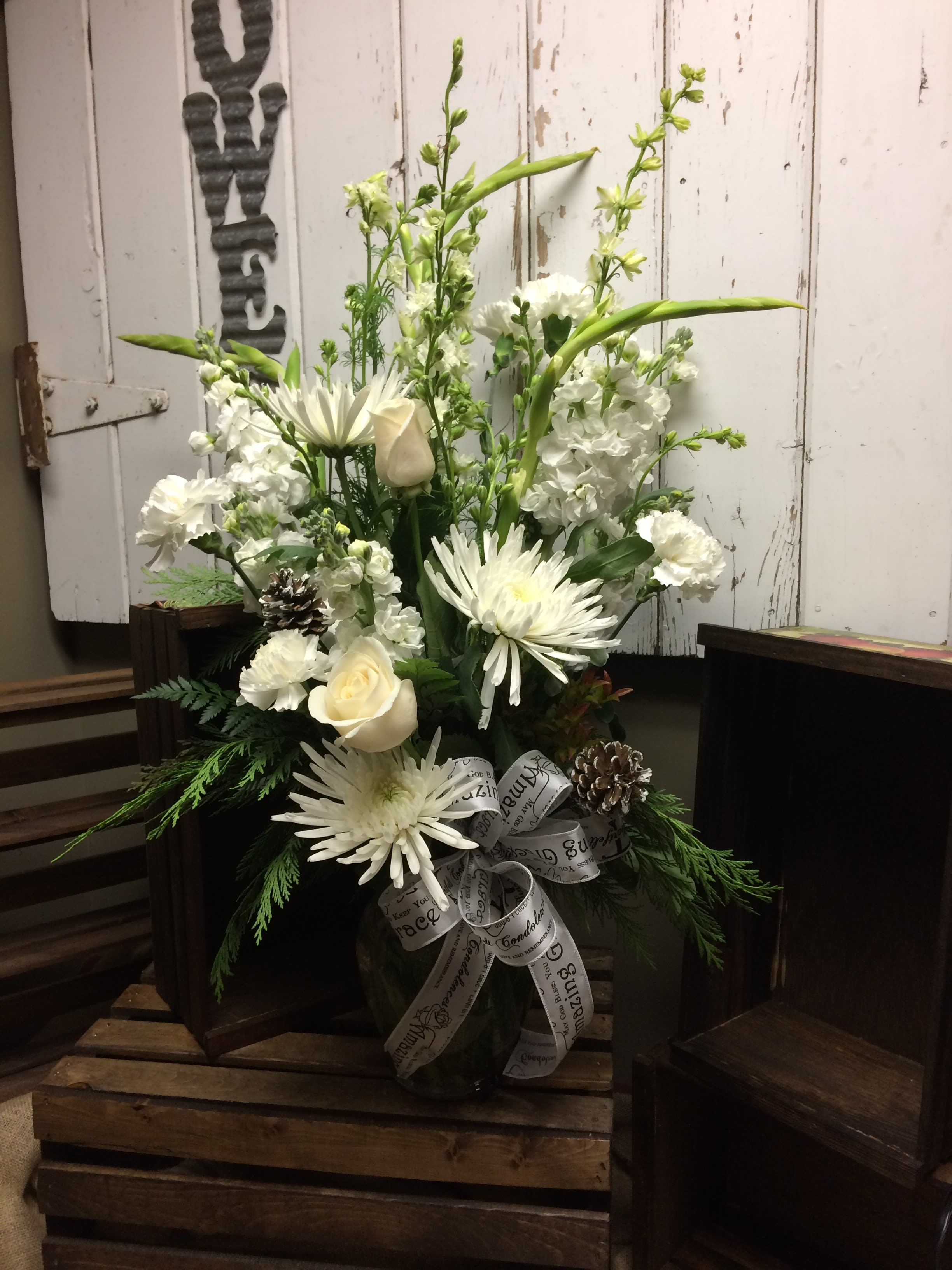 White Splendor - This beautiful tall white arrangement consist of roses, larkspur, stock, carnations and spider mums  can be designed in a vase, basket or tall keepsake container