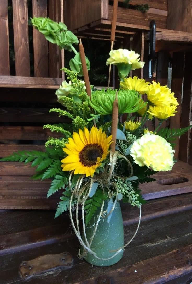 Friendship Bouquet. Custom Designed by Cold Spring Floral - Yellow Sunflower, Green Fuji Mum, Yellow Mums, Green Bells of Ireland, Yellow Carnations and Solidago Vased with a Twine Bow, Accented with Cattails and Seeded Eucalyptus. 