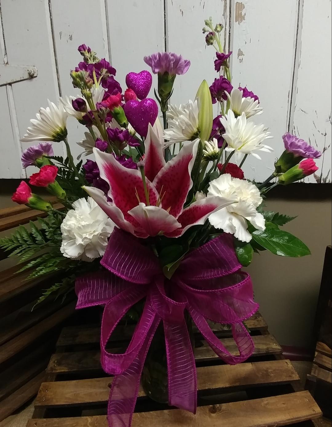 Stargazer Delight Custom Design by Cold Spring - Stargazer Lily, Bright Pink Miniature Carnations, Lavender and White Standard Carnations, Fuchsia  Stock and White Daisies Designed in a Vase with Miniature Heart Picks. 