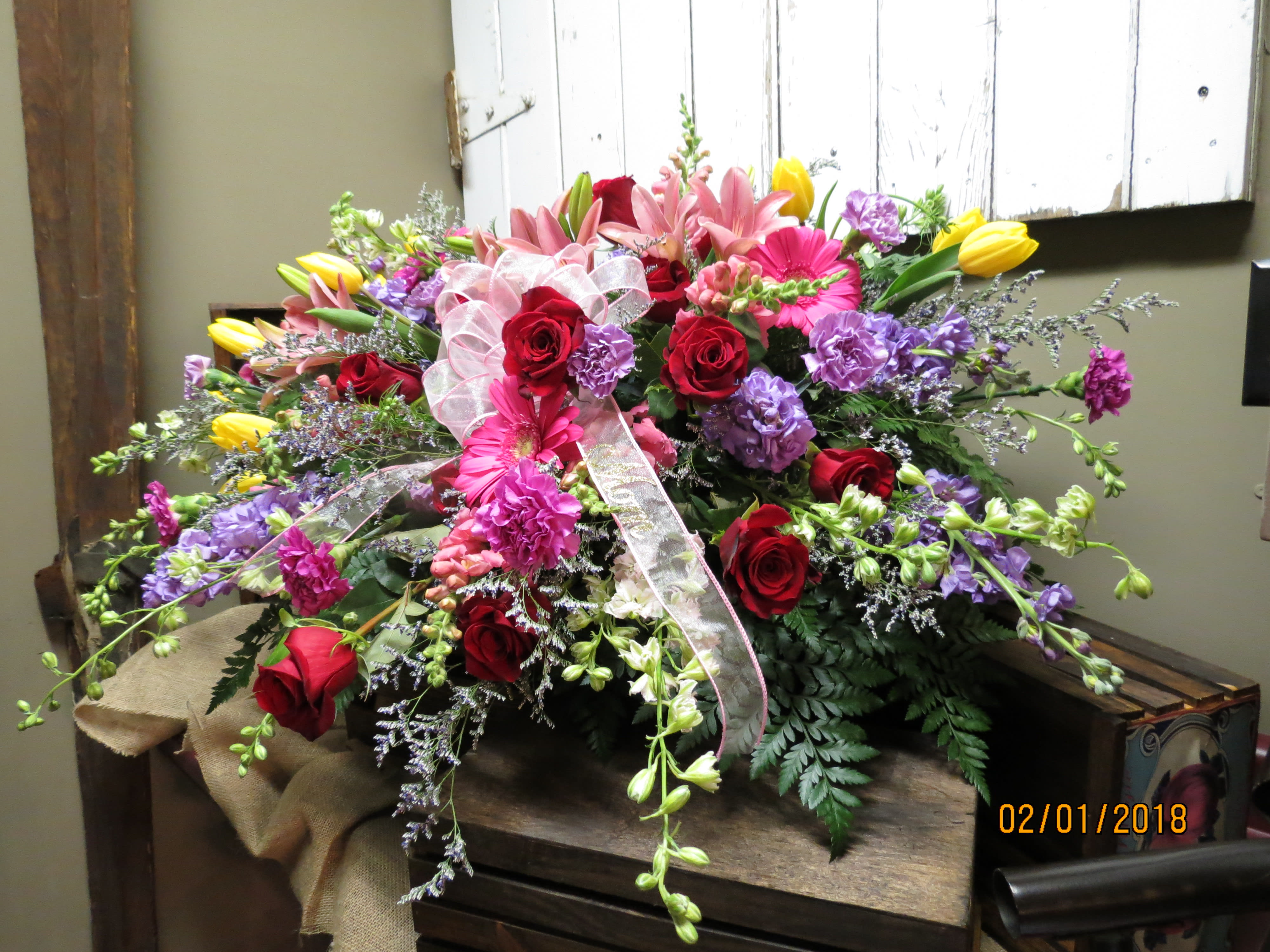 Spring Mix Sympathy Custom Design by Cold Spring Floral - Fresh Spring Mix of Flowers arranged with Care in Loving Memory of Your Loved One. A Bright Mix of Roses, Carnations, Filler Flowers, Tulips, Stock, Larkspur, Snapdragons, Asiatic Lilies and mixed Greenery. Colors of flowers subject to availability.