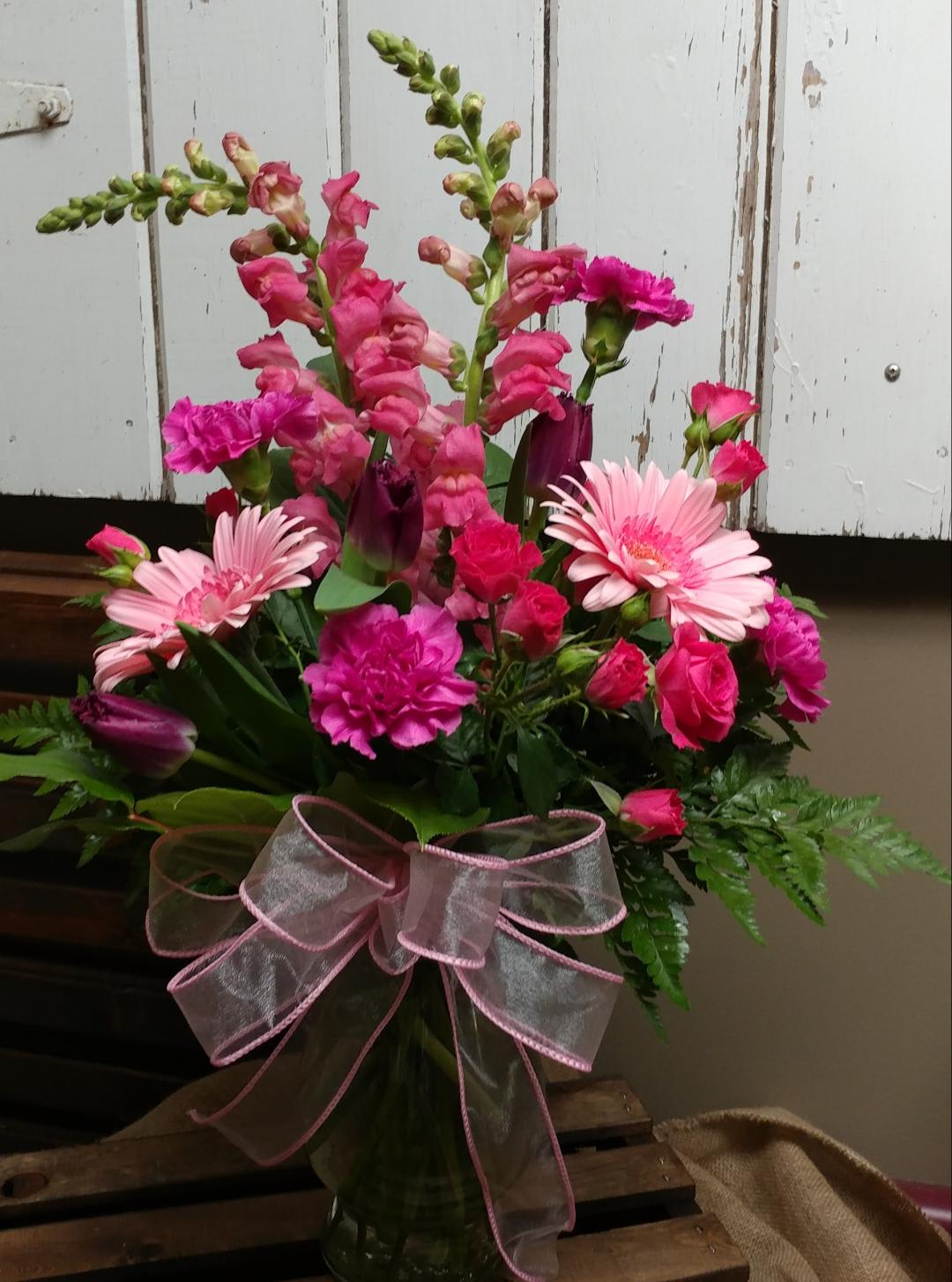 Always Loved Custom Design by Cold Spring Floral - Pink Snapdragons, Light Pink Gerbera Daisies, Hot Pink Spray Roses, and Fuchsia Carnations, Purple Tulips and Mixed Greenery Expertly arranged in a Vase. Colors and Flowers may vary slightly due to availability. 