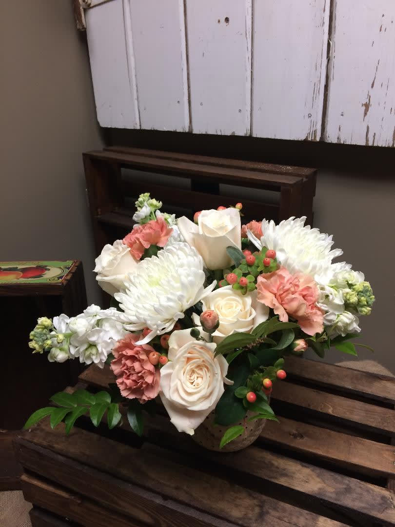 Peach Passion - This arrangement consists of antique peach carntions, White Fuji mums, peach hypericum berry, cream roses and lush greens