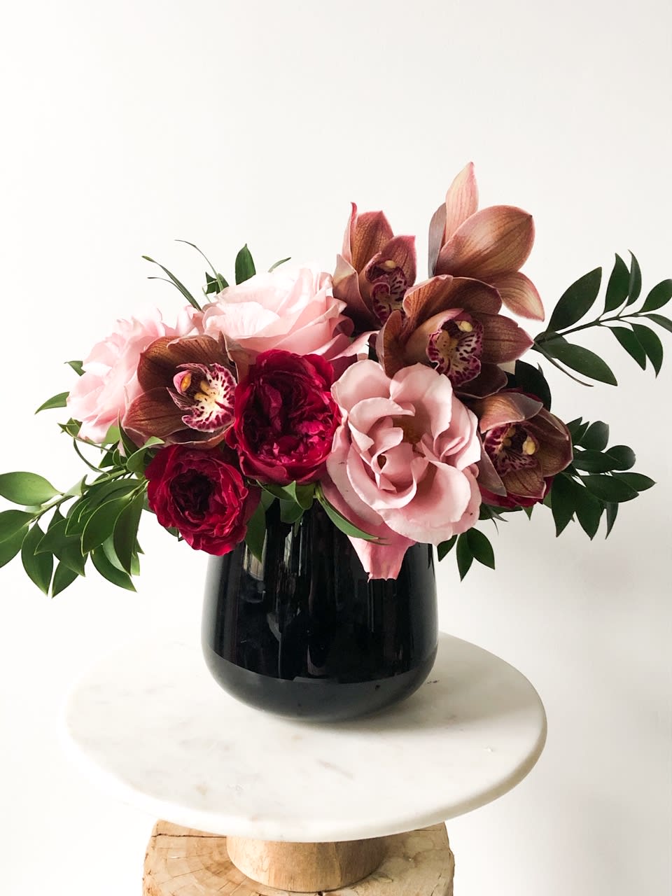 Crazy in Love Crazy in Love - Crazy in love, shades of muted tones. Hot Pink Garden Roses, Subtle Secret Garden Rose, topped off with cymbidium orchids.