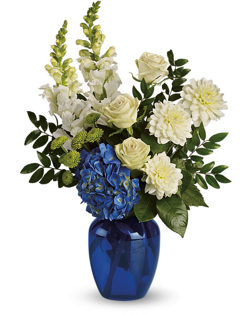 Ocean Devotion - Sending this brilliant blue and white bouquet will surely garner oceans of appreciation from whoever receives it. Dazzling blue hydrangea green roses and button spray chrysanthemums divine white dahlias and snapdragons plus huckleberry arrive in a striking cobalt vase.