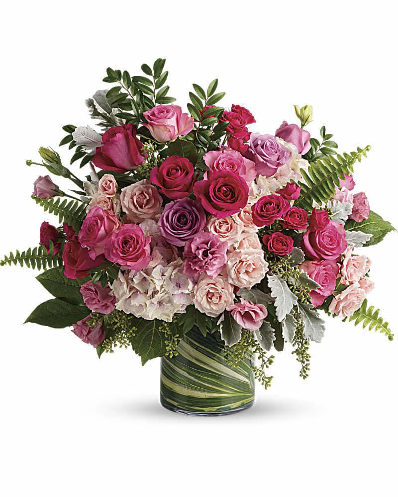 Haute Pink Bouquet - A high-fashion fantasy of roses! When you want to make a grand statement send this dreamy bouquet of posh pink roses and modern greens. This gorgeous bouquet includes light pink hydrangea hot pink roses lavender roses pink roses hot pink spray roses light pink spray roses pink lisianthus dusty miller huckleberry sword fern seeded eucalyptus lemon leaf and variegated aspidistra leaves. Delivered in a large glass cylinder vase.