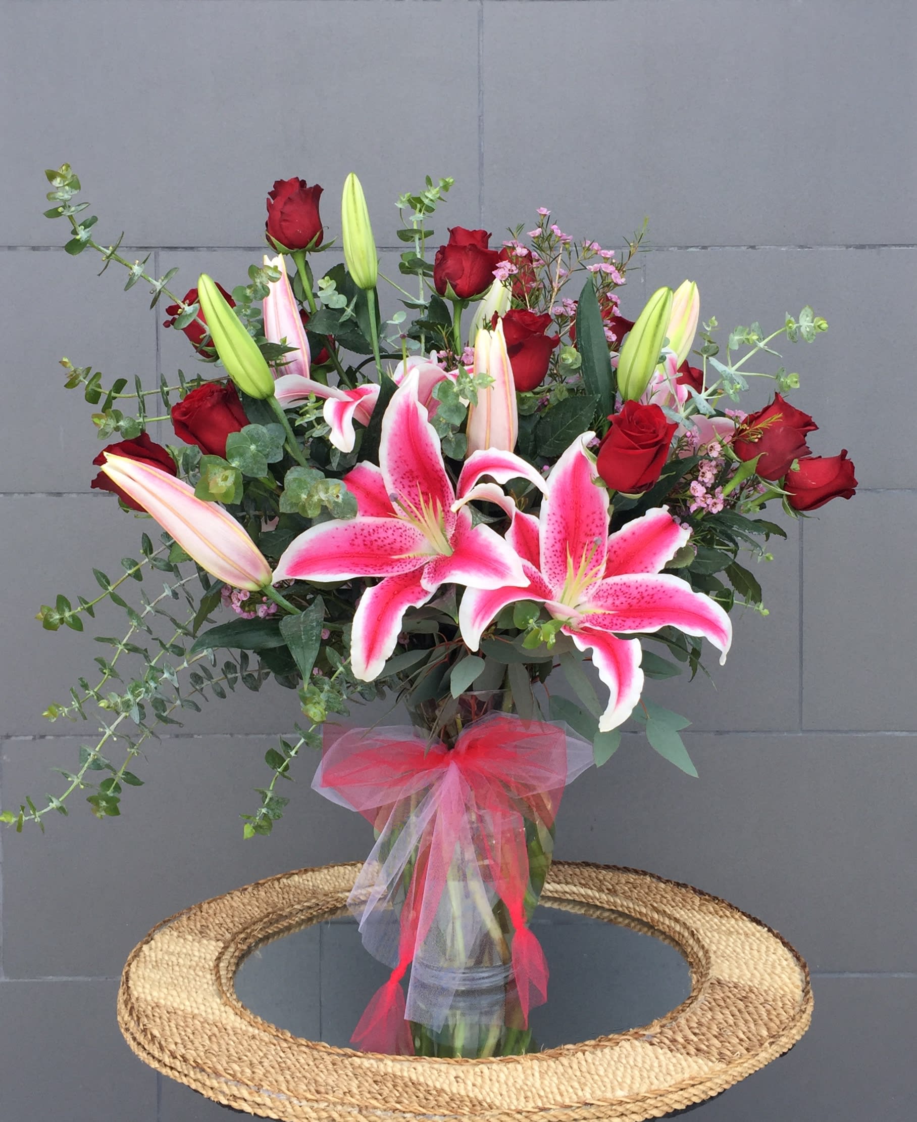 Happy Together - Stargazer lilies, Ecuadorian roses with nice accents in a tall glass vase. CUSTOMER CAN CHOOSE PINK OR WHITE LILY.