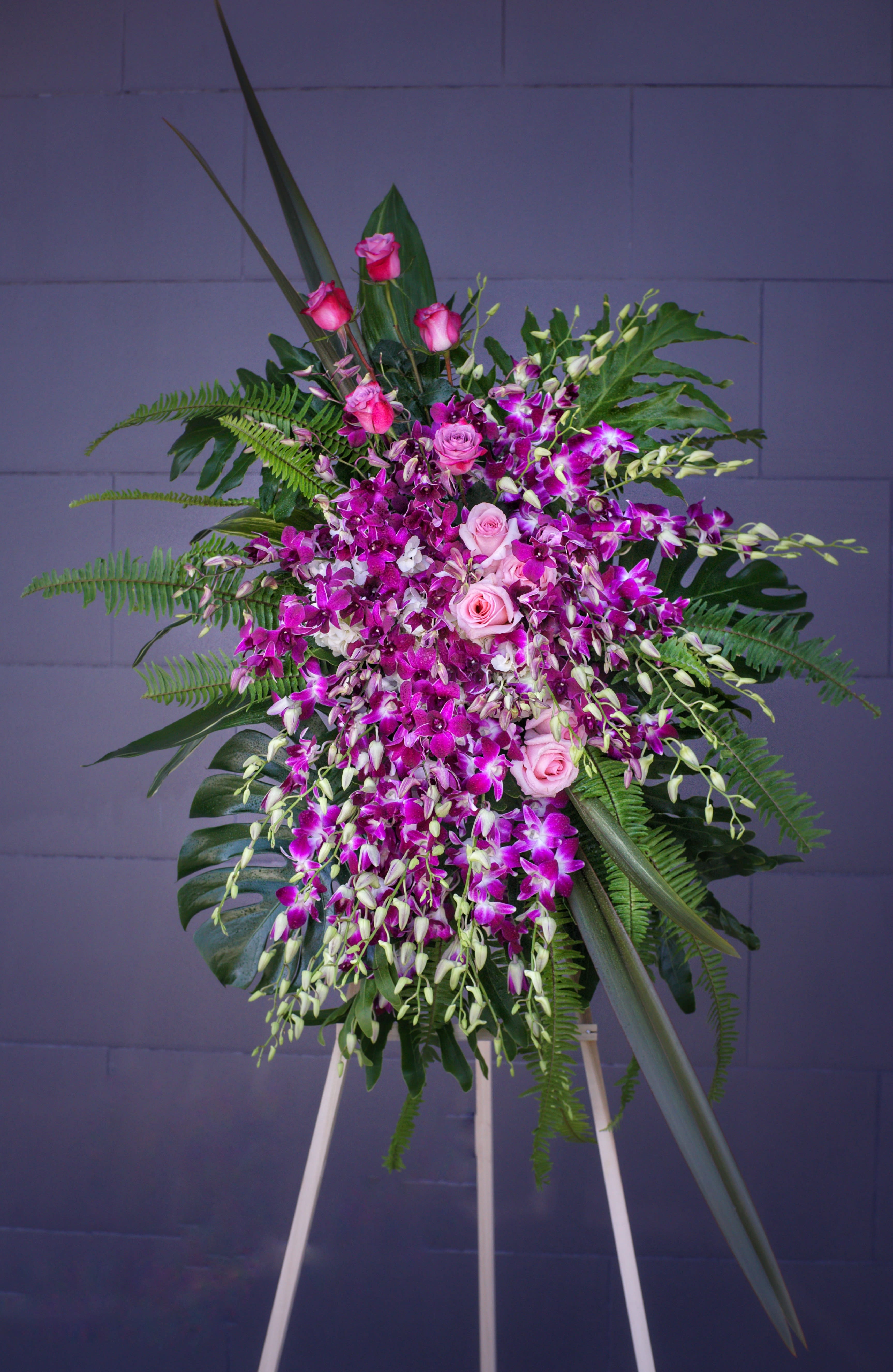 Trip to Heaven - Beautiful standing spray with orchids, roses and tropical accents. COLORS AVAILABLE: PURPLE (AS SHOWN) OR WHITE. PLEASE LET US KNOW.