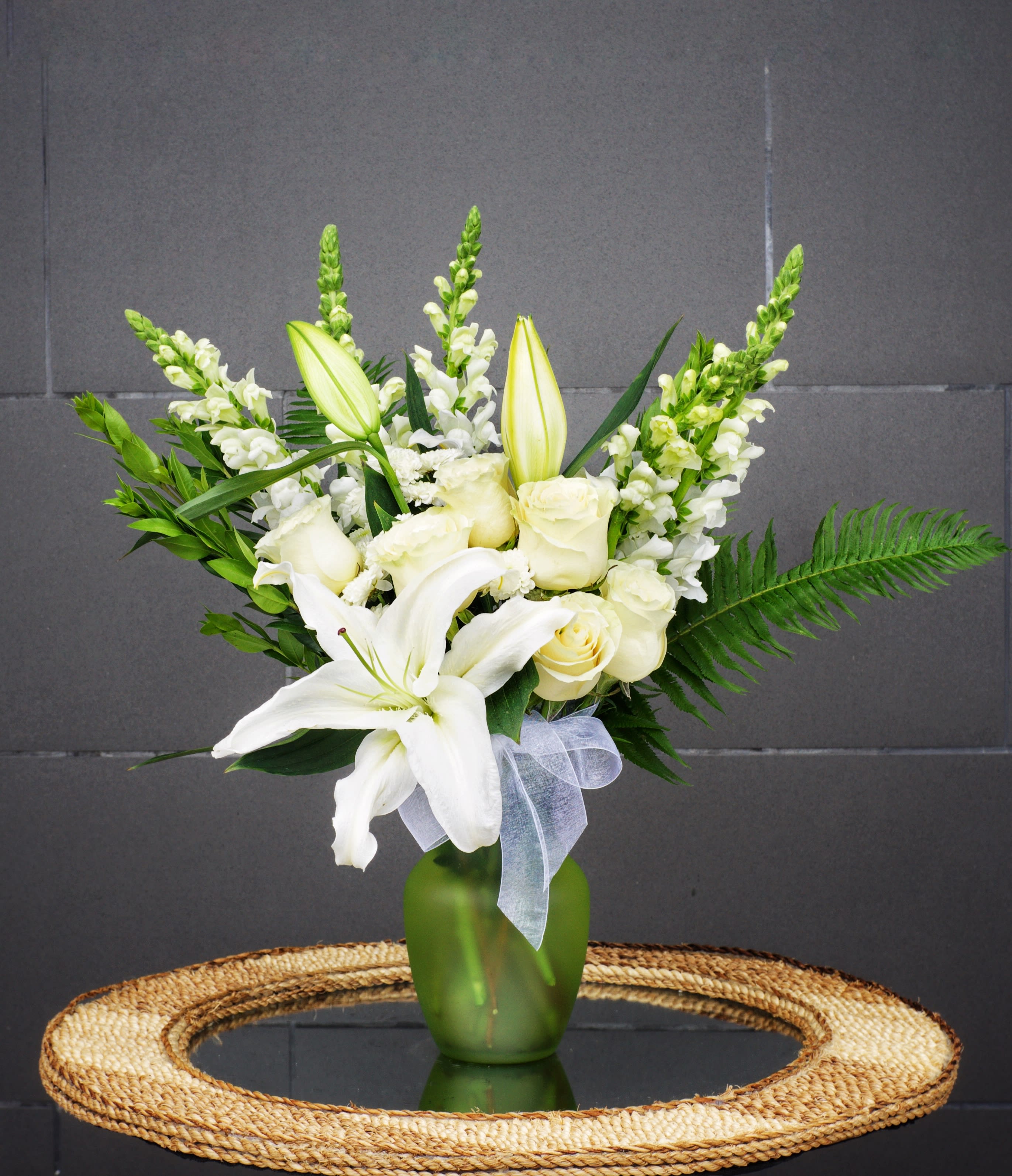 Fresh Kiwi - Fresh like kiwi fruit, this design includes lily, rose, snapdragon and accents in a green vase.