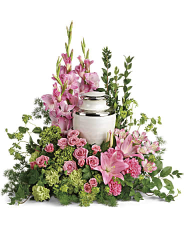  Sacred Solace Cremation Tribute - Surround the cremation urn with gorgeous, graceful pink blooms that show deep gratitude for a beautiful life.  This pretty arrangement includes miniature green hydrangea, pink spray roses, pink asiatic lilies, pink alstroemeria, pink gladioli, pink carnations, green carnations, bupleurum, green ivy, myrtle, ming fern, and lemon leaf. Arrangement does not include urn. 