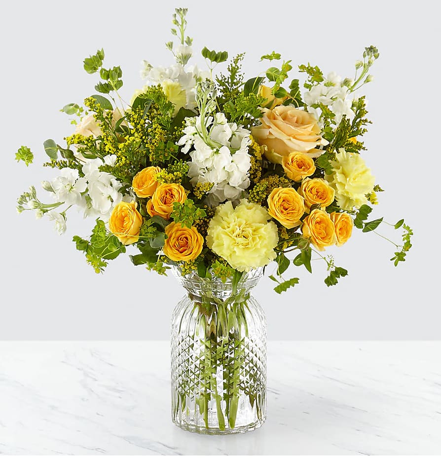 The FTD® Sunny Days™ Bouquet The FTD® Sunny Days™ Bouquet - Give this arrangement to your loved ones and watch their face light up with an arrangement comprised of sunny blooms. Our Sunny Days Bouquet comes together with a collection of peach roses, yellow spray roses, and white stock set in an elegant clear glass vase. Wherever its placed, this bouquet is sure to brighten up the room. GOOD bouquet is approx. 17"H x 16"W.