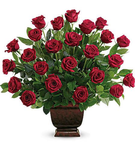 T224-1A Teleflora's Rose Tribute - As true as the love symbolized by a red, red rose are the heartfelt memories and deep feelings embraced with this classic and elegant expression of tribute. Two dozen red roses, accented by salal, are presented in an exclusive Noble Heritage Urn. Approximately 27&quot; W x 26&quot; H 