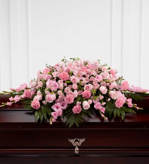 The Sweetly Rest Casket Spray - The Sweetly Rest Casket Spray is a wonderful way to commemorate a life abundant in beauty and love. Blushing pink roses, spray roses, carnations, gladiolus, mini carnations, and Asiatic lilies are elegantly arranged amongst an assortment of lush greens to create a sophisticated display meant to bedeck the top of their casket at the final memorial service.