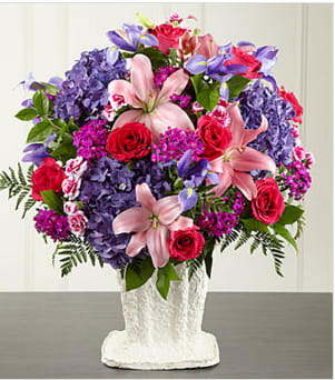 The FTD® We Fondly Remember™ Arrangement - This generously scaled arrangement makes a beautiful and comforting expression of sympathy. This impressive, colorful combination of pink roses and Asiatic lilies, vibrant blue iris, fuschsia dianthus, purple carnations and hydrangea is handcrafted by an FTD artisan florist. An extraordinary choice that thoughtfully expresses your love and profound sense of loss for a wake, funeral or graveside burial service. Your purchase includes a complimentary personalized gift message.