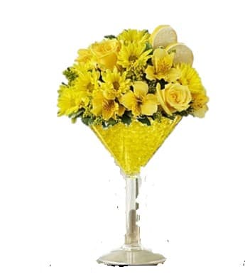 Lemon Drop Martini Lemon Drop Martini - Offer a toast with our awesome Lemon Martini. Our floral version of the cosmopolitan cocktail is hand-crafted inside an oversized acrylic martini glass from cheerful yellow roses, daisies, alstroemeria and solidago. Topped with a faux lemon slice garnish, it's enough to fill anyone with sunshine and smiles.