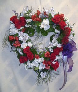 Our Open Heart Wreath Our Open Heart Wreath - Remembering a loved one with this open heart wreath, expresses your love, with red roses, alstromeria, white spray roses, caspia and select assorted greenery. Color and flowers may be substituted as requested.