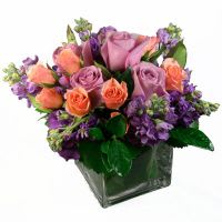 Purple Passion Purple Passion - A gentle mix of Purple Stock, Lavender Roses and Pink Spray Roses makes this arrangement soft and heavenly scented. Its a great floral piece for sprucing up your desk or home with a touch of beauty! Colors or flowers may be substituted.