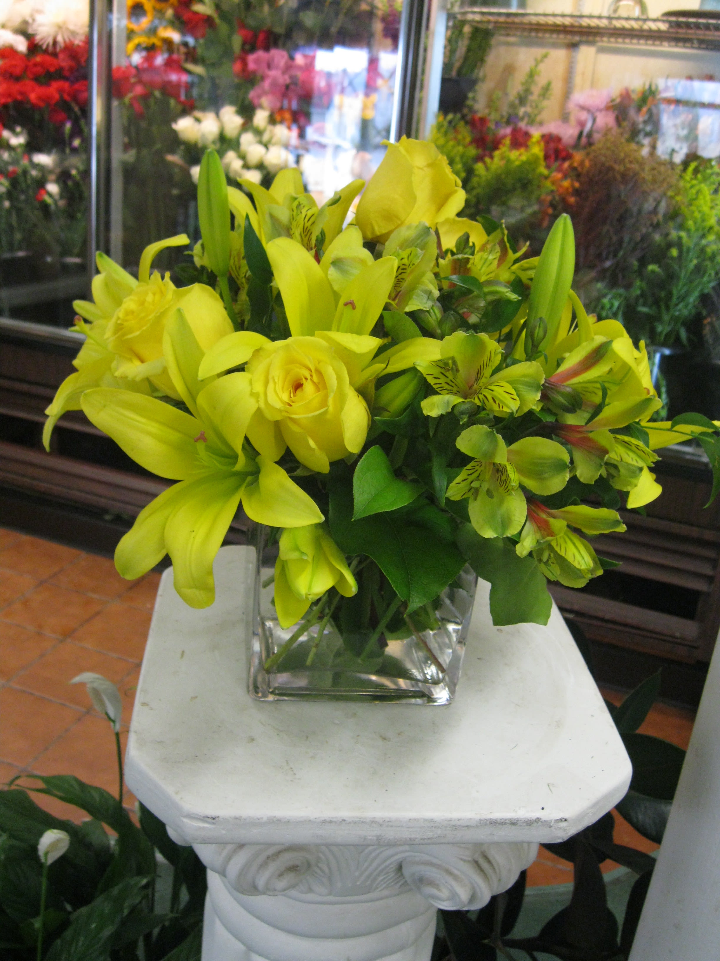 Yellow Delight - This contemporary cubes has assiatic lillies,alstomeria, yellow roses and assorted greens.  This will brighten anyones day!