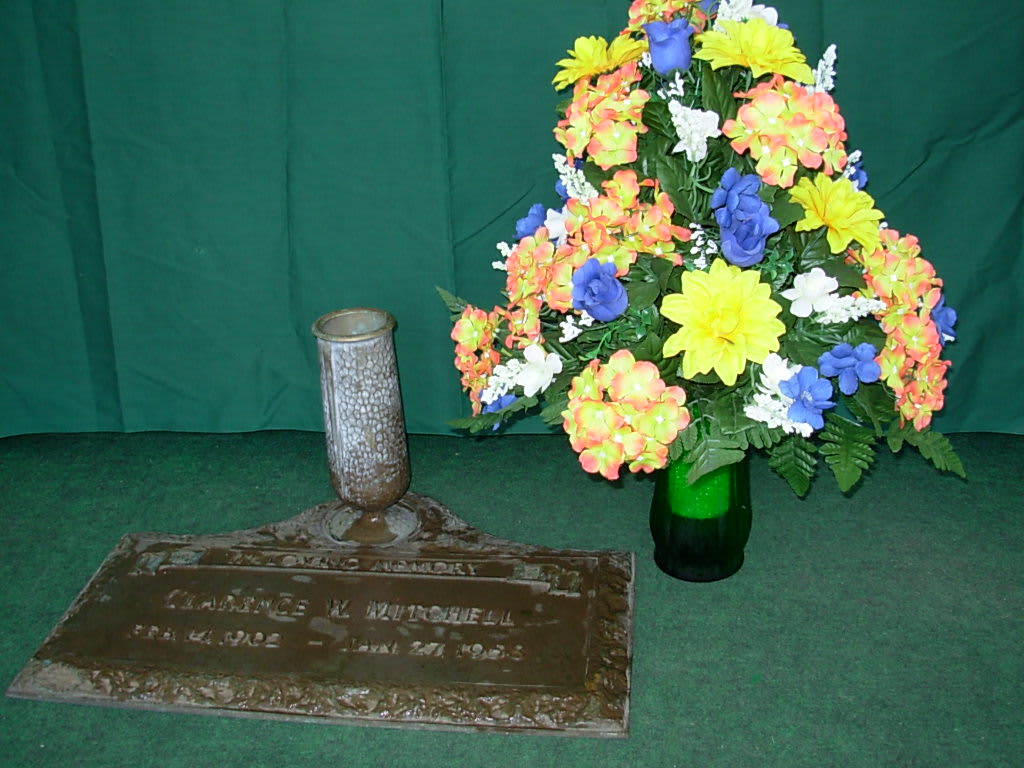 SILK CEMETARY VASE ARRANGMENT NEW-S21 - Our silk CEMETERY VASE ARRANGEMENT  is made of silk-permanent flowers and is made all the way around and is available in many colors and flower combinations..  We can be delivered this arrangement in a glass vase  to the funeral home for the funeral service and then after the bronze grave marker and bronze   vase has been installed , the family can place this arrangement in the grave marker vase. We have several cemeteries in our area that have a section  where this style of grave marker is used.. This arrangement style if only for delivery to the funeral home for the funeral service or can also be for pick us at our store as WE DO NOT DELIVER TO CEMETERIES. Please phone us at 1-800-331-5358 for your special needs      BRONZE GRAVE MARKER IS NOT INCLUDED..It is pictured for display purposes only. 