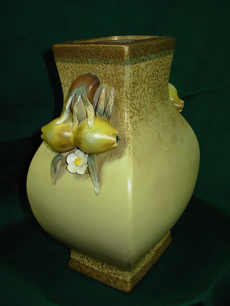 POMEGRANATE CHINESE VASE  NEW-G57 - This unique CHINESE POMEGRANATE VASE stands 10 1/2 inches tall and is 7 inches wide. The handles of this vase are pomegranates with flowers. This quality ceramic  vase makes an excellent gift for most any occasion and we can box and gift wrap and deliver your gift here in the city  Sumter.  If you would like a floral arrangement in this vase please phone us at 1-800-331-5358  for all your floral and gift needs. 