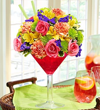 Sangria Bouquet - Product ID: 91856   EXCLUSIVE Spice things up with our fresh floral version of the popular wine punch. Our florists gather a kaleidoscope of roses, carnations, alstroemeria, poms and statice and hand-arrange them with in a chic acrylic martini glass to resemble a glass of sangria. Send one today and you'll have them dancing the samba in no time. Vibrant arrangement of roses, carnations, alstroemeria, poms, statice and variegated pittosporum Artistically hand-designed by our florists in an oversized acrylic martini glass filled with ruby red crystal gel; glass measures 10.5&quot;H Extra Large arrangement measures approximately 14&quot;H x 9&quot;L Large arrangement measures approximately 13&quot;H x 8.5&quot;L Medium arrangement measures approximately 12&quot;H x 8&quot;L Small arrangement does not include alstroemeria and measures approximately 12&quot;H x 7&quot;L Our florists select the freshest flowers available so colors and varieties may vary