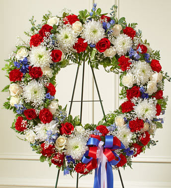 Serene Blessings Red, White &amp; Blue Standing Wreath - Product ID: 91311   This beautiful red, white and blue wreath is a dignified expression of your feelings of love and care for a beloved veteran or patriot. Exquisitely crafted by our expert florists, it features the freshest red and white roses, blue delphinium and more, creating an unforgettable tribute to honor their life. Standing wreath arrangement of fresh red and white roses and carnations, blue delphinium and more Accented by vibrant greenery Appropriate for family, friends and business associates to send directly to the funeral home Our florists use only the freshest flowers available, so colors and assortment may vary Large measures approximately 32âH x 32âW without easel Small measures approximately 28&quot;H x 34&quot;W without easel Easel may not be available in all areas