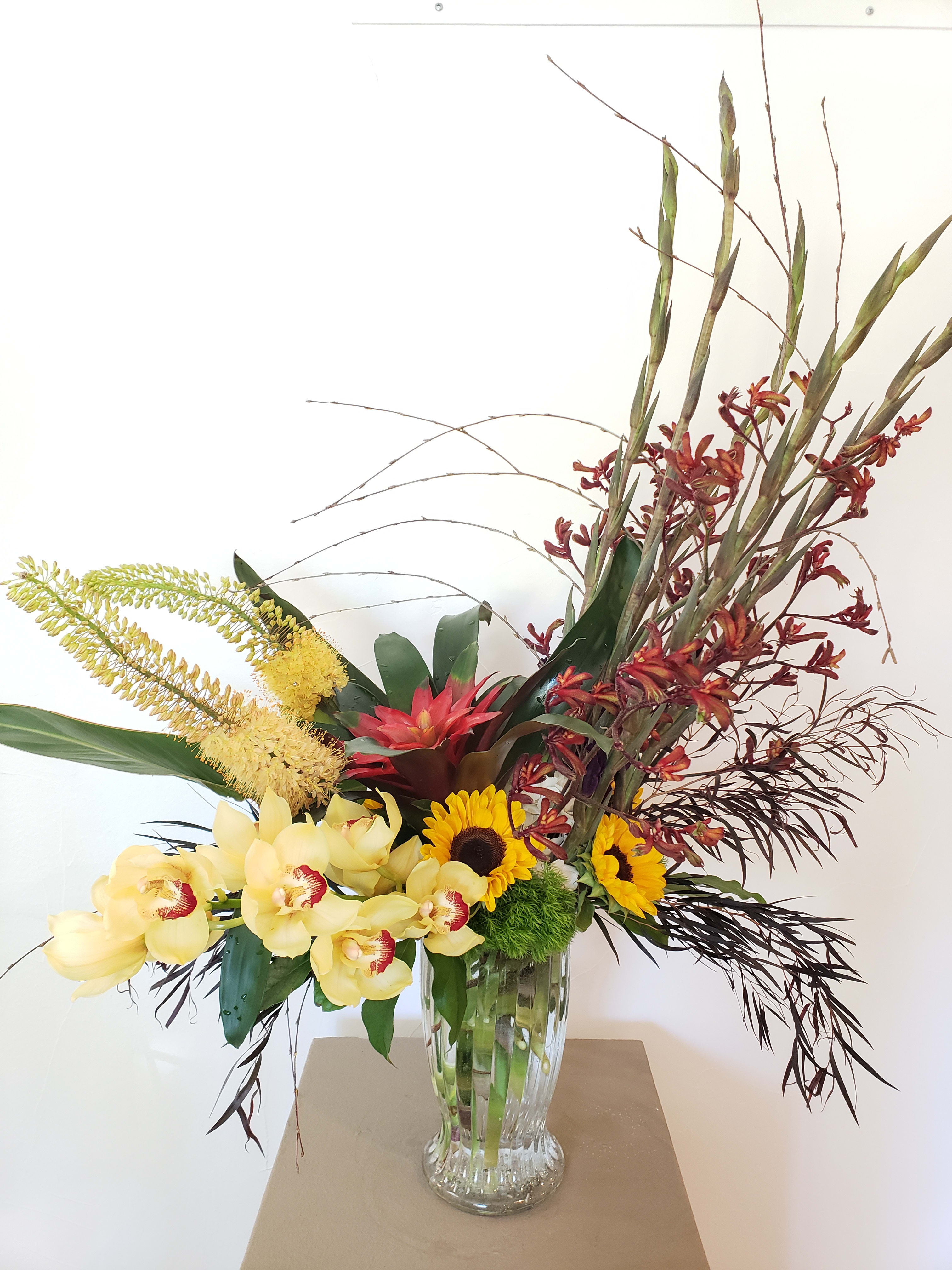 Sunset Bloom Sunset Bloom - Cymbidium orchid, sunflowers, gladiolus, bromeliad, green dianthus balls, kangaroo paw, eremurus