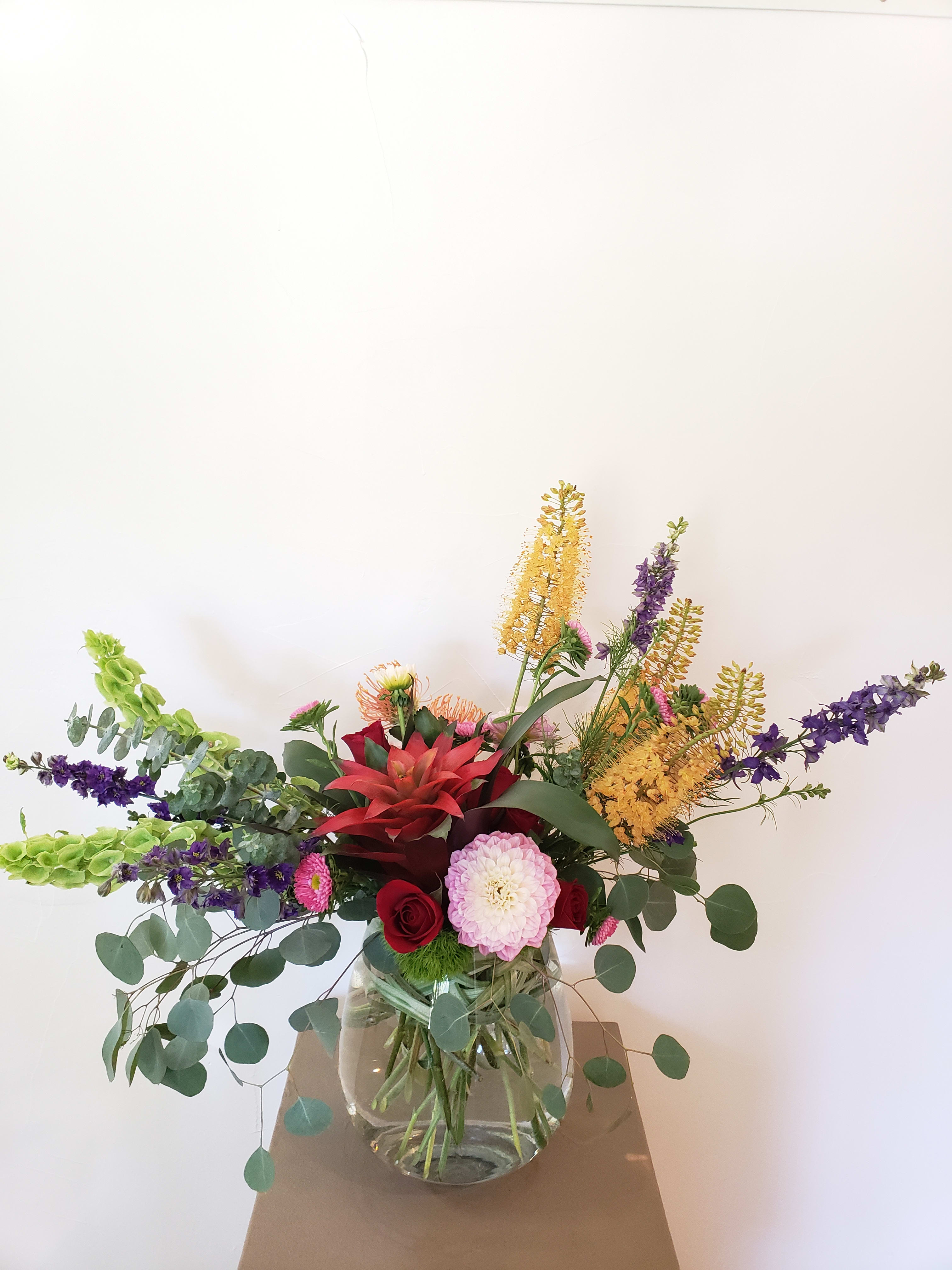 Summer time fun  - Silver dollar eucalyptus, green dianthus balls, bromeliad, delphinium, bells of Ireland, pin cushion protea, roses, aster, dahlia, eremurus 