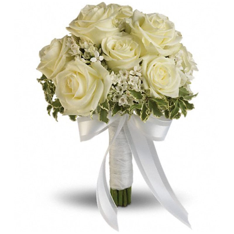 Lacy Rose Bouquet Lacy Rose Bouquet - Delicate white bouvardia and pittosporum lend a lacy look to this breathtaking bouquet of white roses, wrapped with sheer organza ribbon. White roses and bouvardia contrasted by variegated pittosporum. Orientation: N/A All prices in USD ($) Standard T186-2A