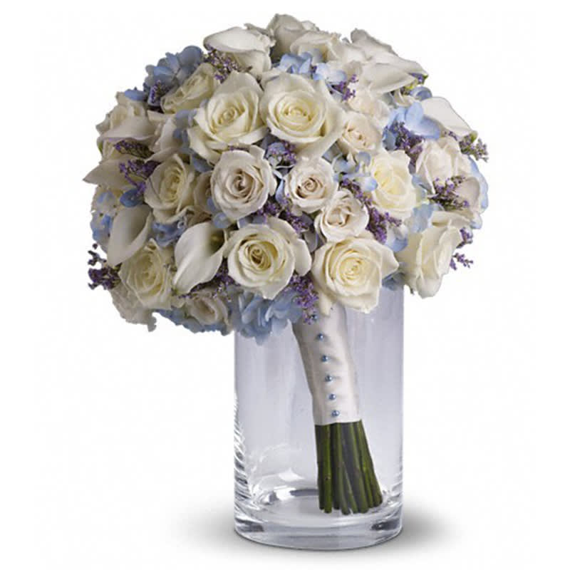  Lady Grace Bouquet - Full of classic charm, this country-inspired bouquet features delicate limonium among light blue hydrangea, white roses and mini callas.  Lavender limonium, light blue hydrangea, white roses and miniature callas.      Orientation: N/A      All prices in USD ($)      Standard      T183-1A 