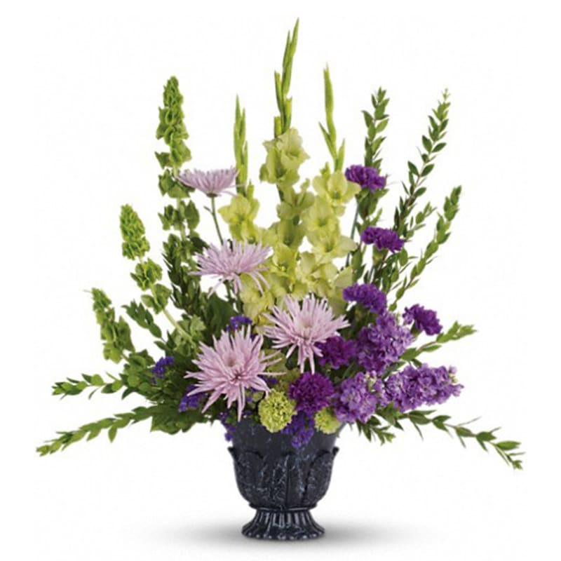 Teleflora's Cherished Memories Teleflora's Cherished Memories - This ethereally lovely bouquet of green gladioli, lavender stock, purple carnations and more in a timeless-tribute urn is a stunning choice for the memorial service. The serenely beautiful bouquet includes green gladioli, lavender stock, green carnations, purple carnations, lavender spider chrysanthemums, bells of Ireland and purple sinuata statice, accented with assorted greenery. Delivered in a timeless tribute urn. Orientation: One-Sided All prices in USD ($) Standard T268-1A