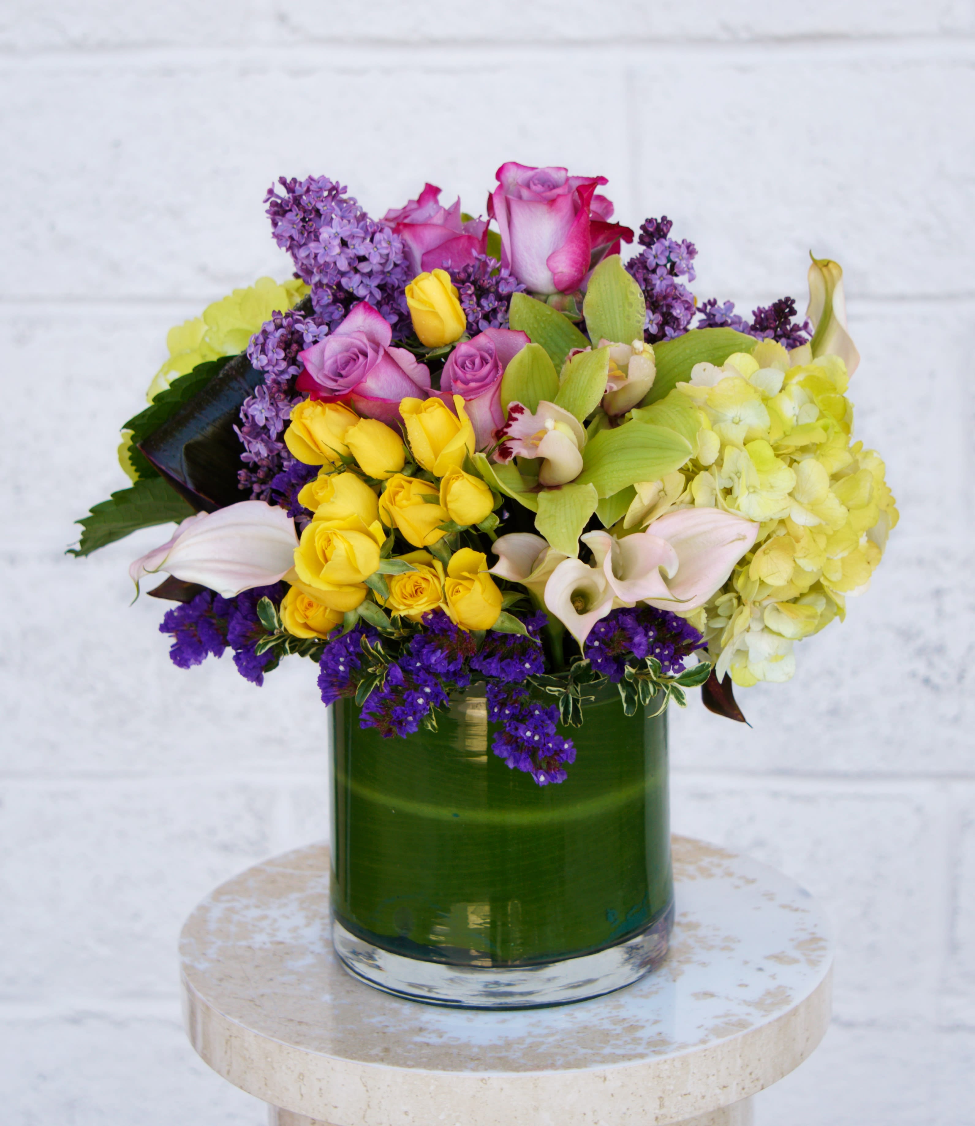 Victoria - Beautiful design including orchid, calla lily, rose, hydrangea... and accents in a nice vase.