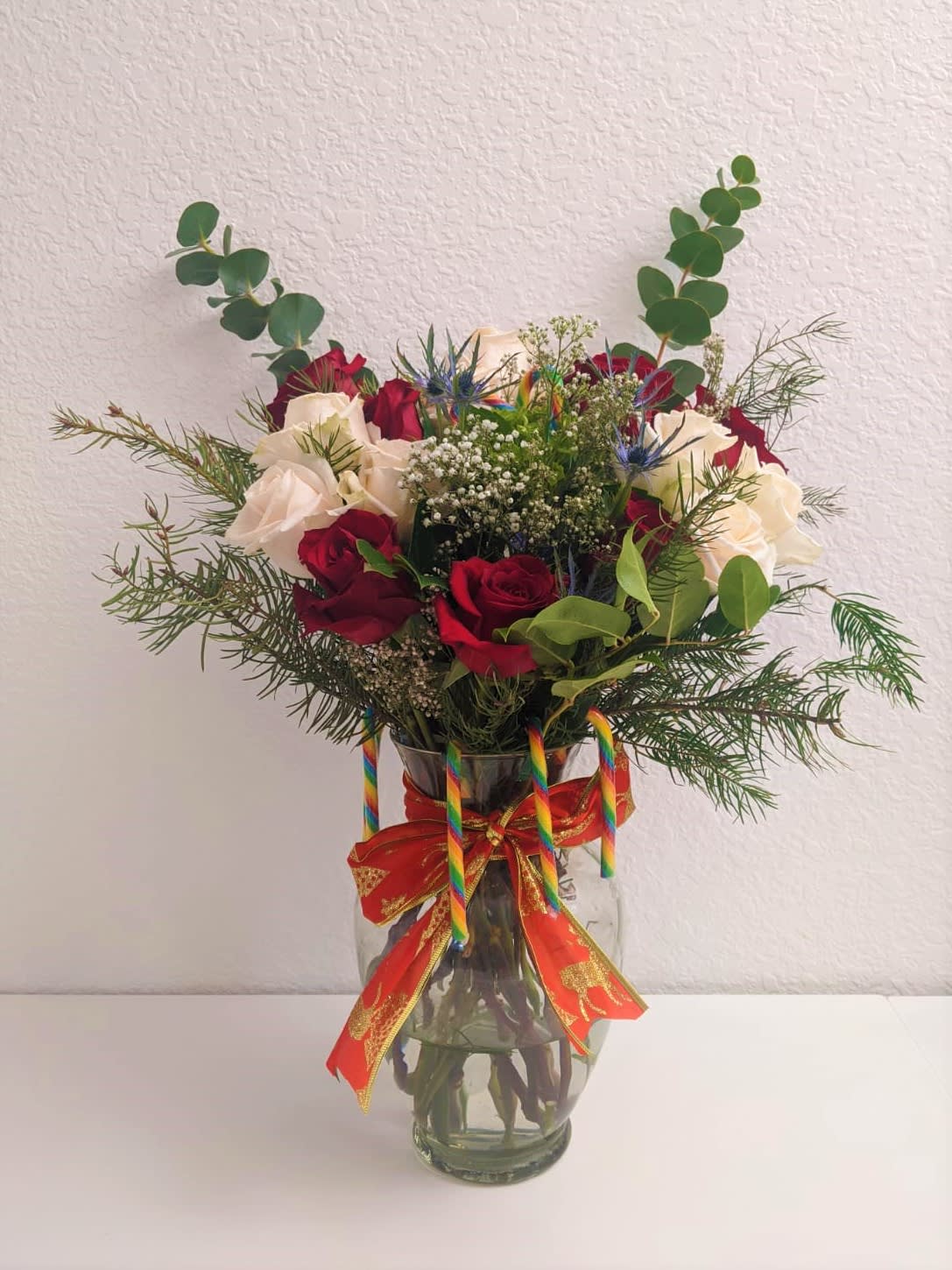 Holiday Festival Vase by Flower Infinity  - A beautiful vase holding roses, eucalyptus, candy cane and other pretty flowers.
