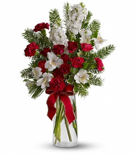 Festive Fragrance Festive Fragrance - This tall display of fresh red and white flowers and evergreens will fill a room with the festive fragrance of Christmas. A big red bow adds a celebratory touch of class.