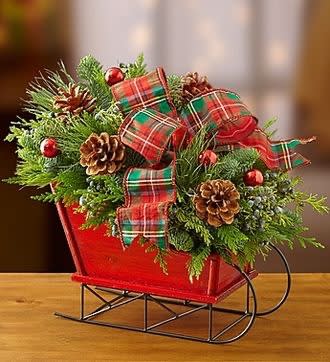 Christmas Sleigh Christmas Sleigh - Christmas sleigh filled with holiday greens, hypericum berries, pine cones and a beautiful holiday ribbon.